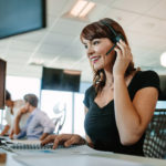 Beautiful mature business woman talking on headset