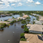 Flooding in Florida caused by tropical storm from hurricane Debby. Suburb houses in Laurel Meadows residential community surrounded by flood waters in Sarasota. Aftermath of natural disaster